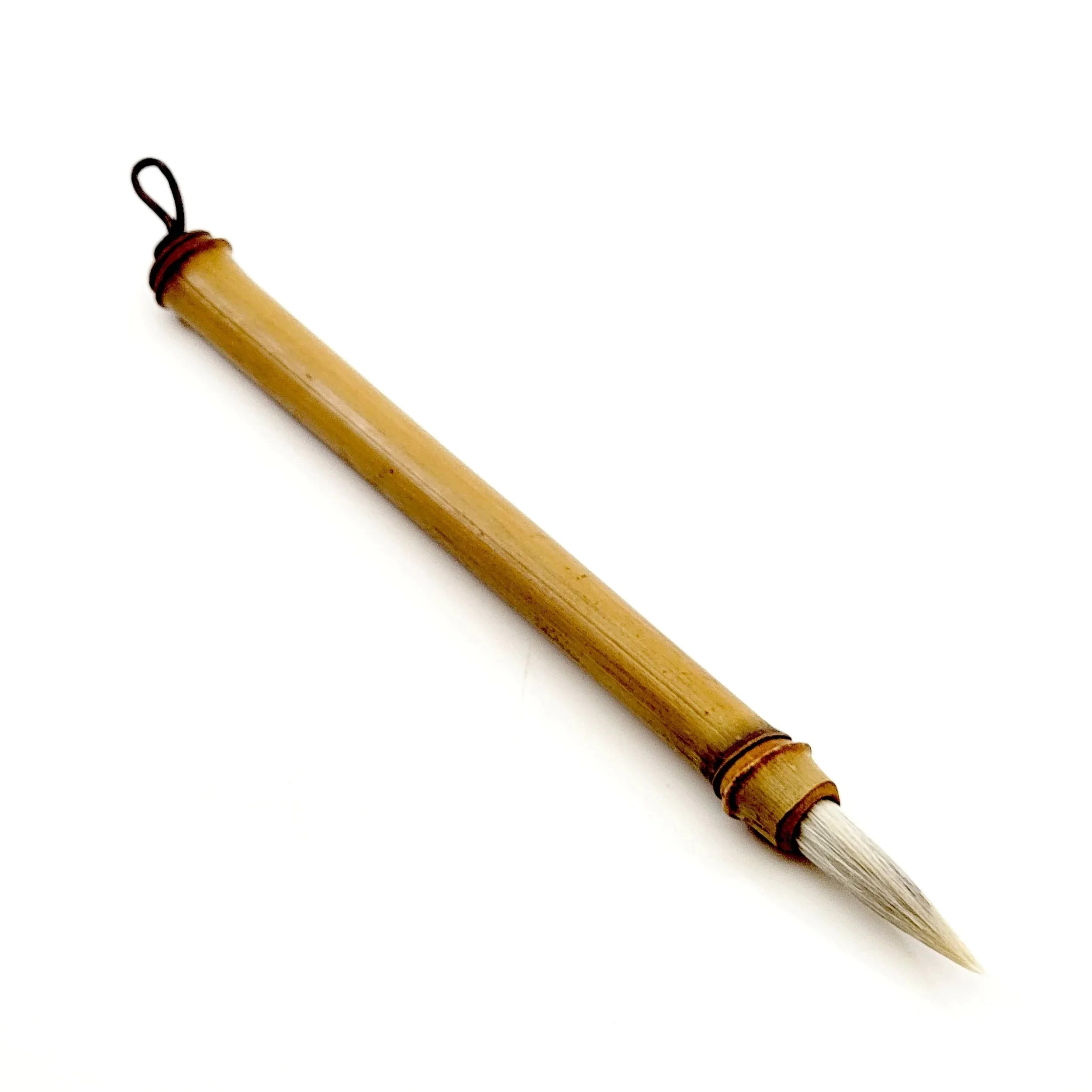 A traditional Chinese calligraphy brush with a bamboo handle and white bristles.