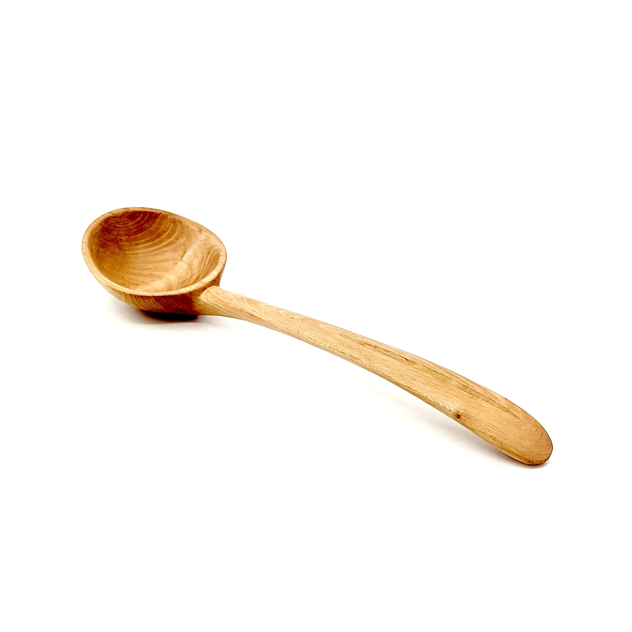 A small wooden spoon with a rounded bowl and a long handle, lying on a white surface.