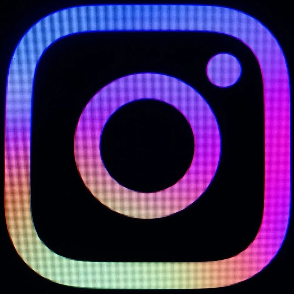 Instagram logo with a colorful gradient on a black background.