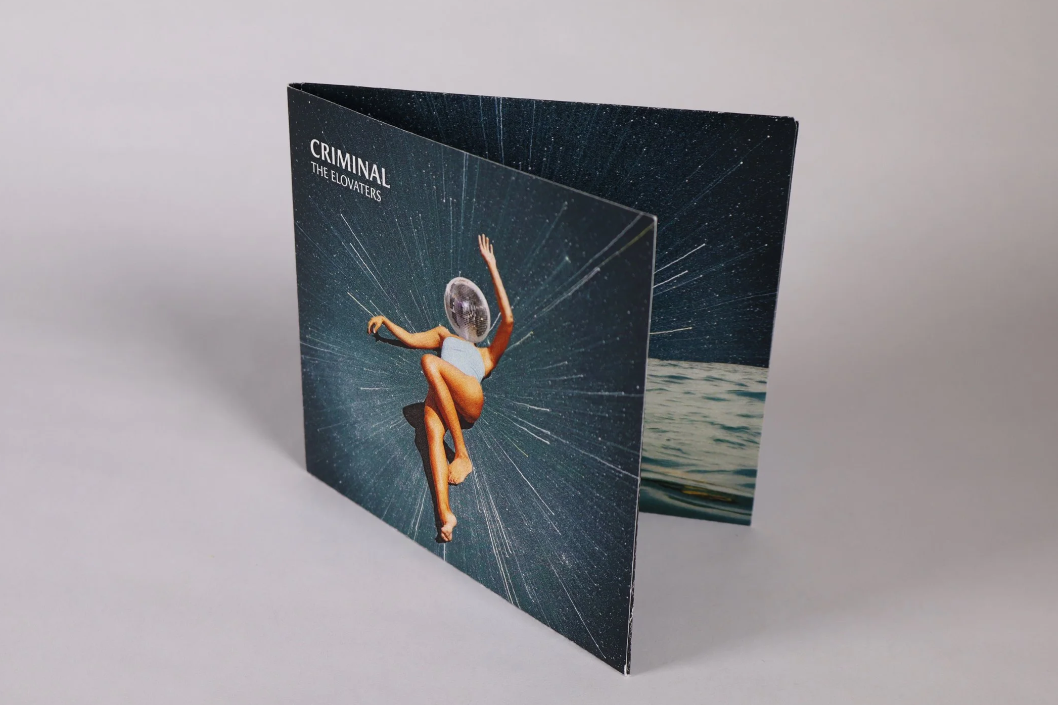 A vinyl record album cover for the band Criminal's 'The Elovaters' featuring surreal art of a woman with a disco ball head, floating in space with a starry background.