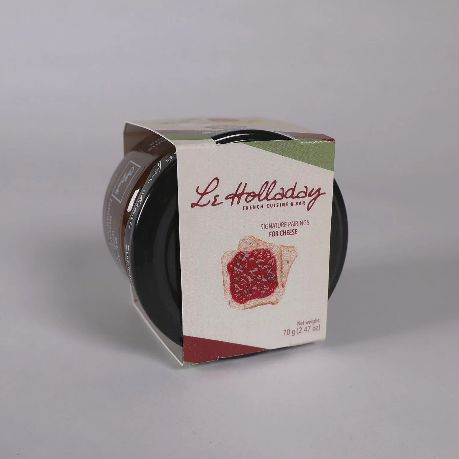 A small jar of Le Holliday French cuisine & bar cheese with a label showing a toast with cheese and red jam, and the text 'Signature pairings for cheese.'