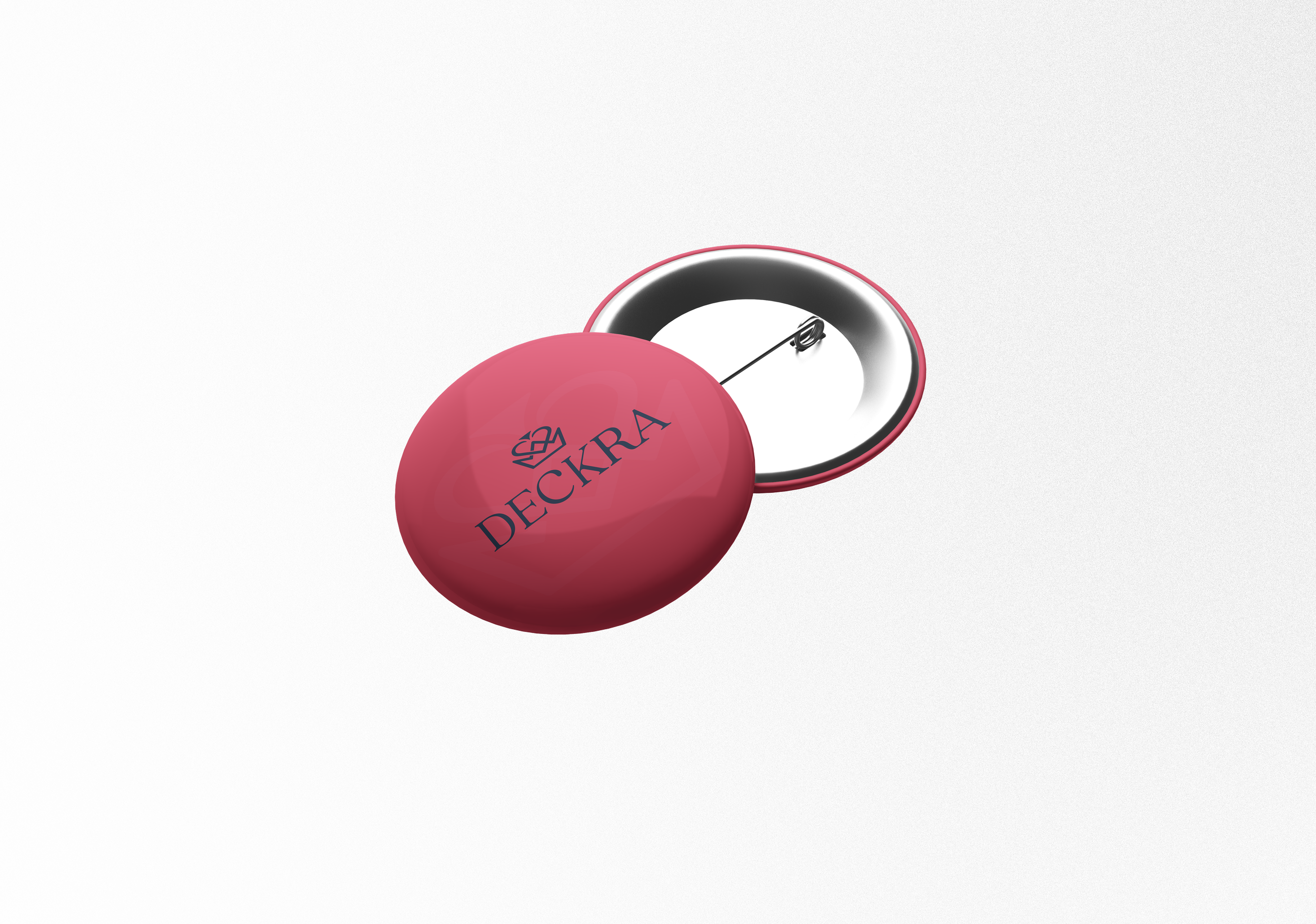 Red round badge with the text 'DECKRA' and a crown logo, opened to reveal the pin on the back.