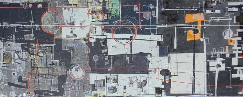 Aerial view of an urban area with buildings, streets, and construction markings.