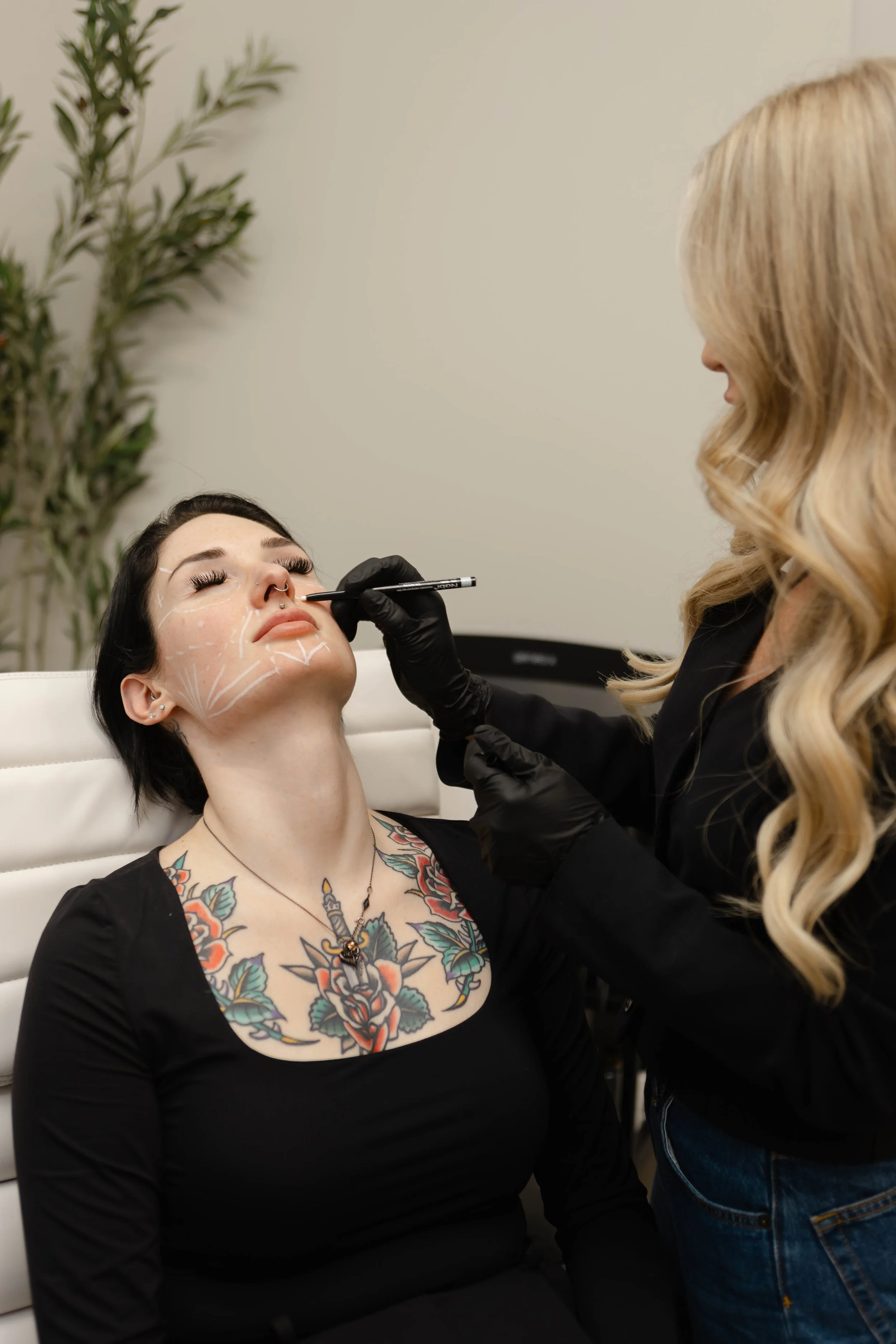 A woman with tattoos getting her Sculptra a biostimulator at Refinery Aesthetics & Wellness.