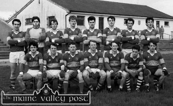 Black and white photo of a vintage soccer team with 13 players, some standing and some sitting, wearing striped uniforms, in front of a building with a sign reading 'the maine valley post'.