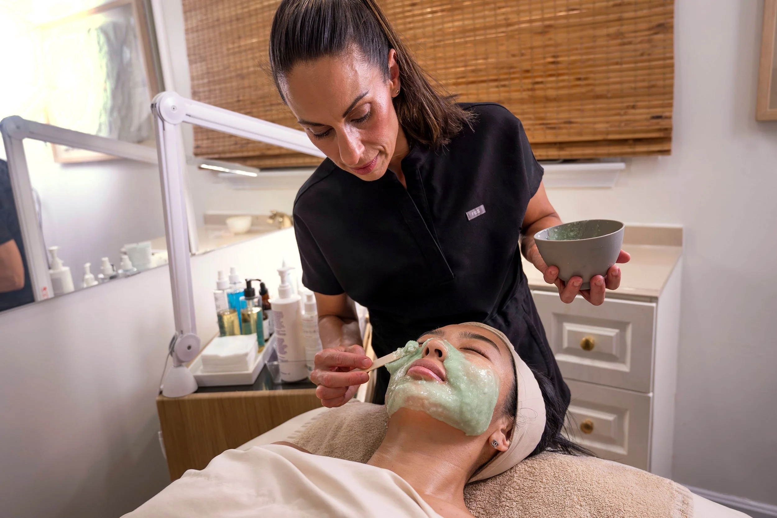 Liz Clapsis providing a facial treatment.