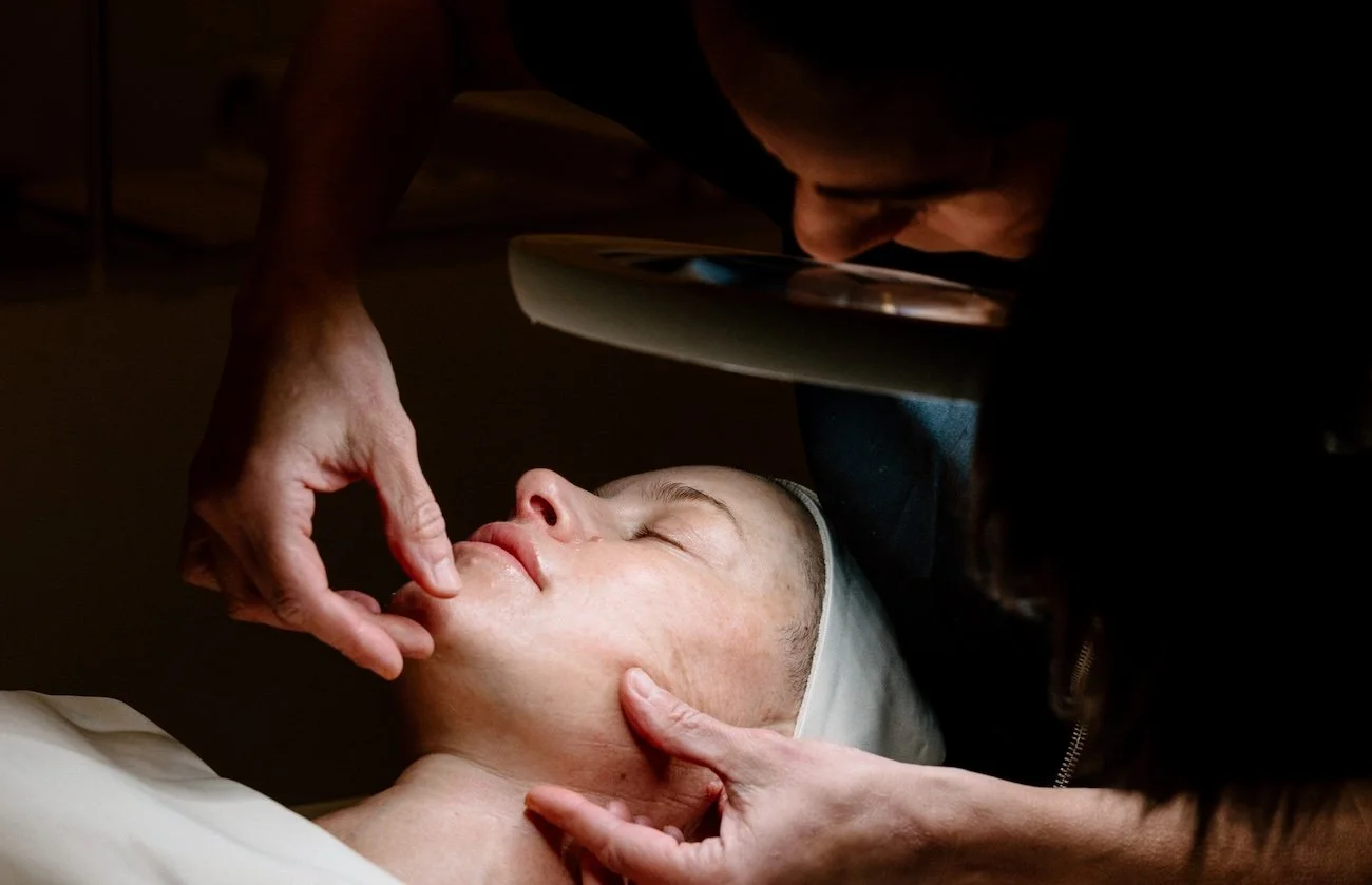Person receiving a facial massage from Liz Clapsis