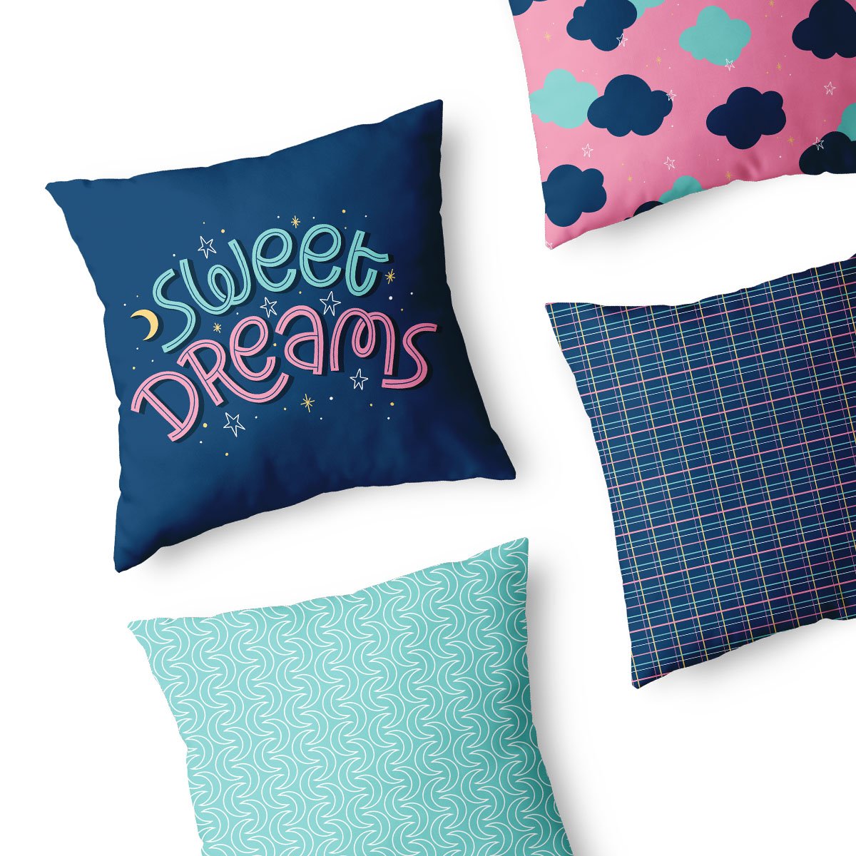 A collection of decorative throw pillows with colorful patterns, including one with the phrase 'Sweet Dreams' on a dark blue background, surrounded by stars and a crescent moon.