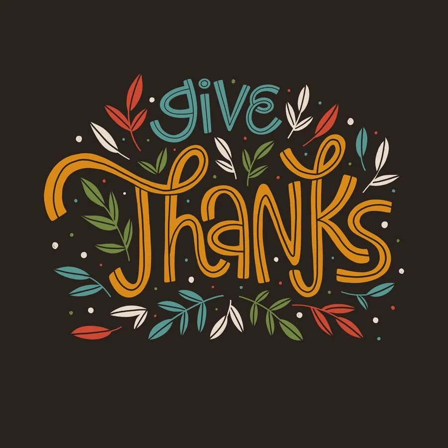 Colorful hand-lettered message 'give thanks' with decorative leaves and dots on a dark background.