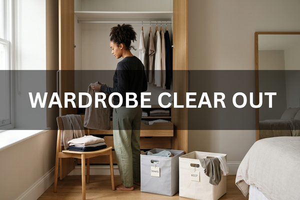 Person clearing out a wardrobe and organising clothes into storage