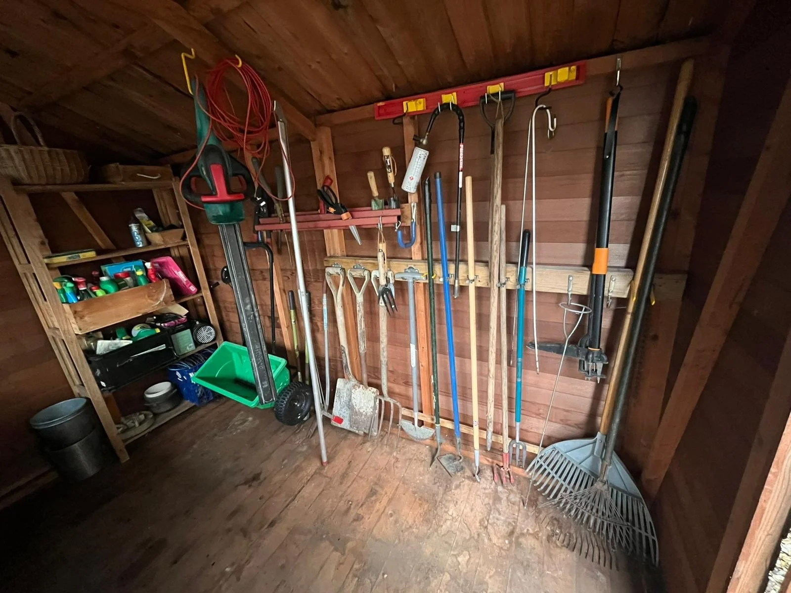 Image of a very tidy and organised shed with tools hanging on the wall after a decluttering session.