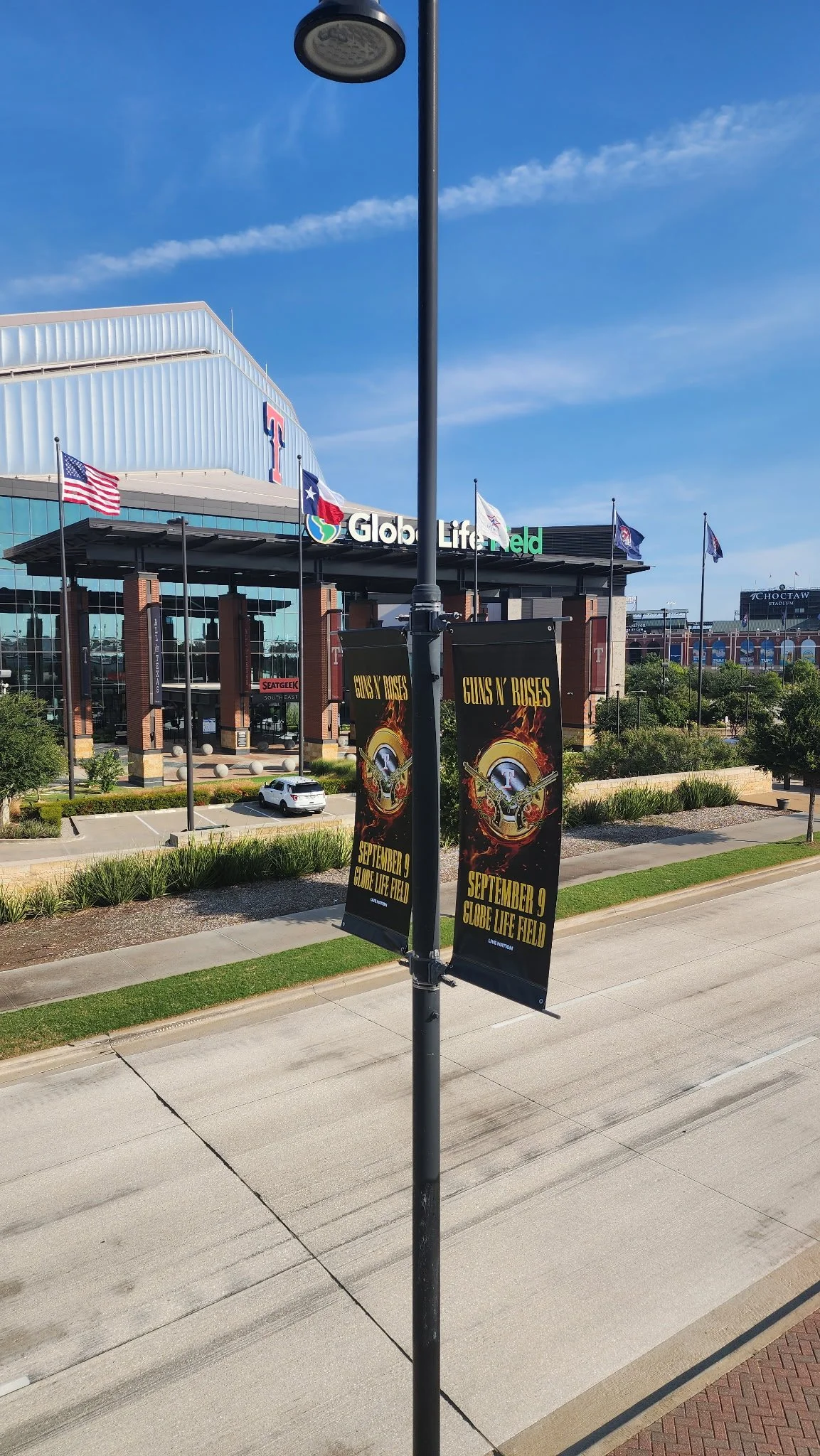 Banner advertising Guns N' Roses concert on September 9 at Globe Life Field outside a stadium.