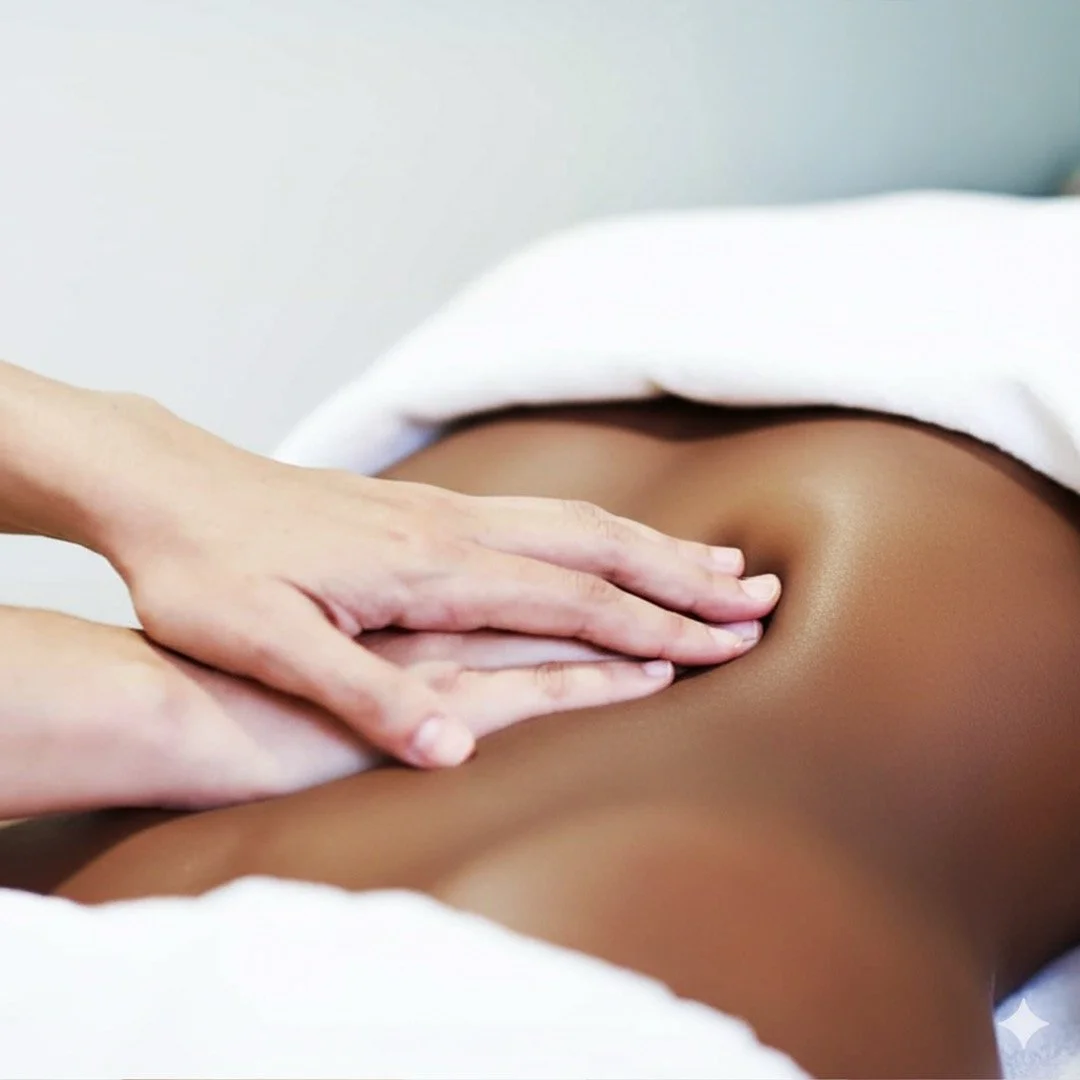 Close-up of a person receiving a massage on their back, with a therapist's hand applying pressure.