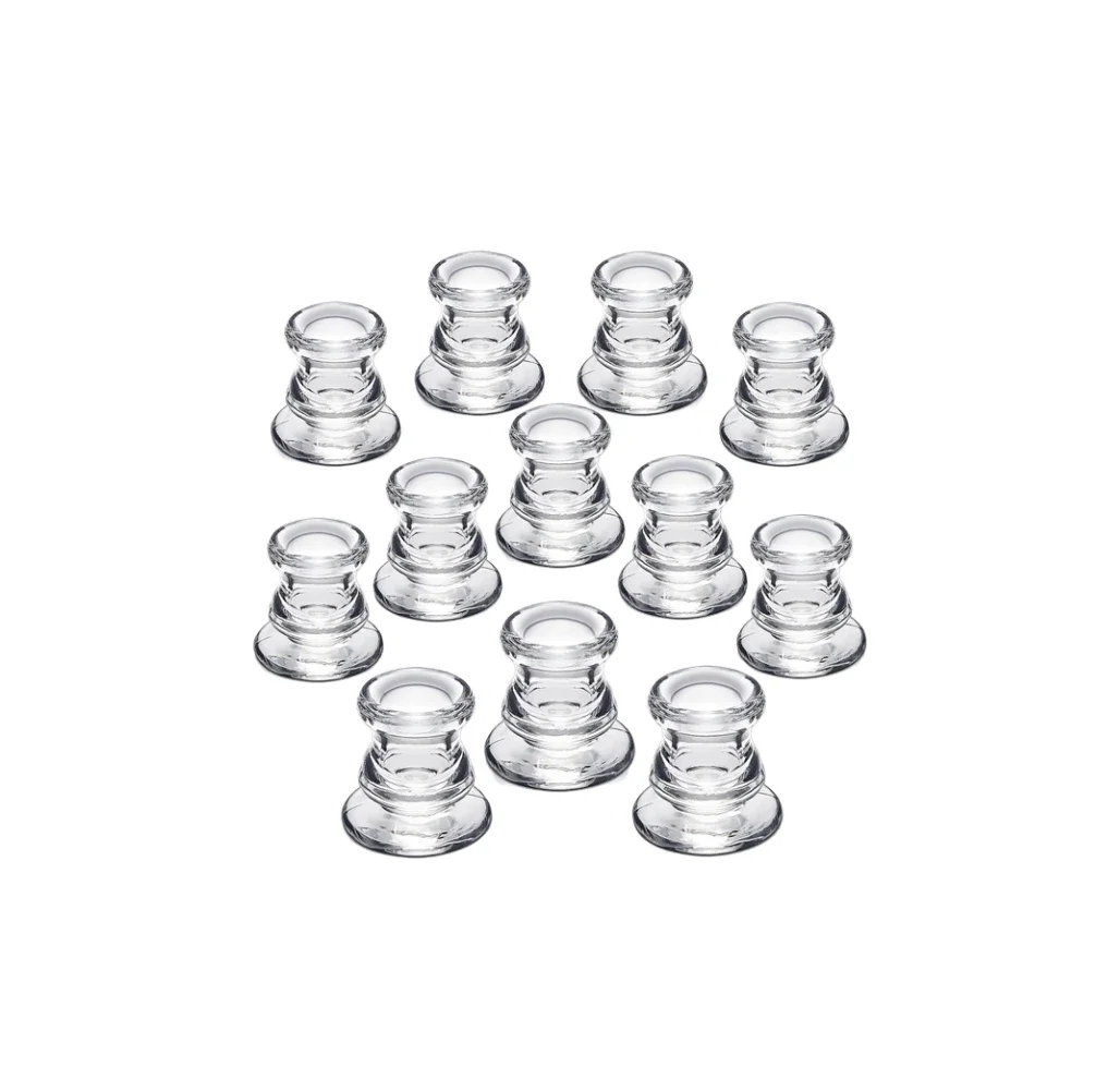 A group of 13 clear glass candle holders arranged on a white background