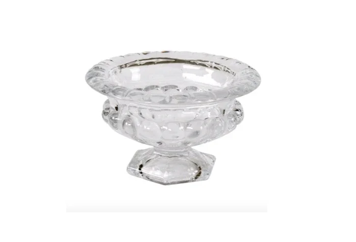 Clear glass decorative bowl with ornate design on a white background.