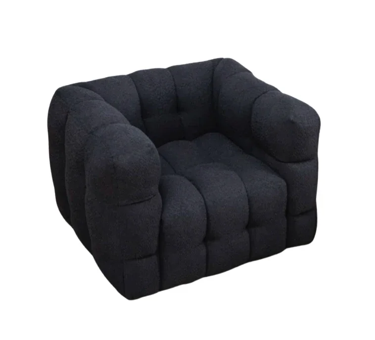 Black, plush, armchair with a rounded and tufted design