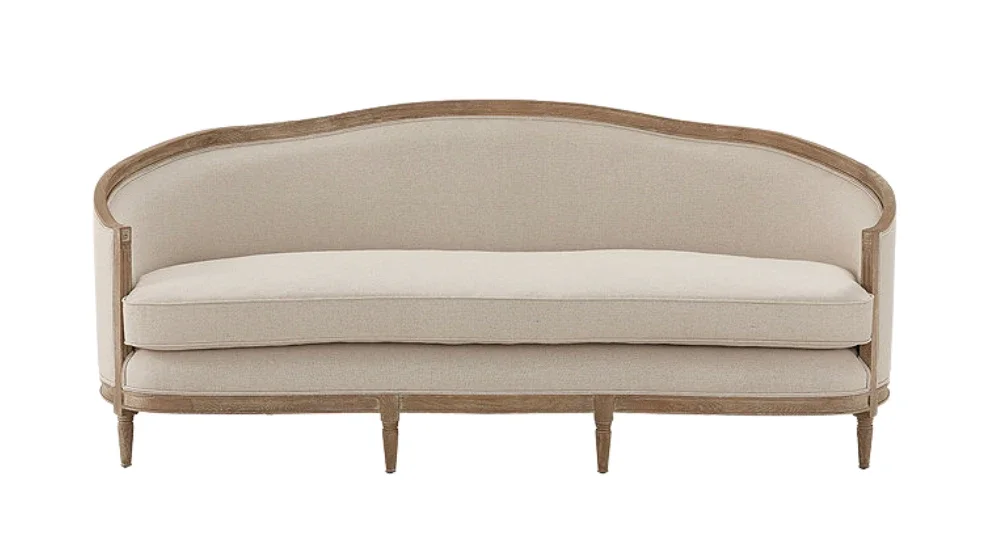 A beige upholstered sofa with a curved wooden frame and wooden legs.