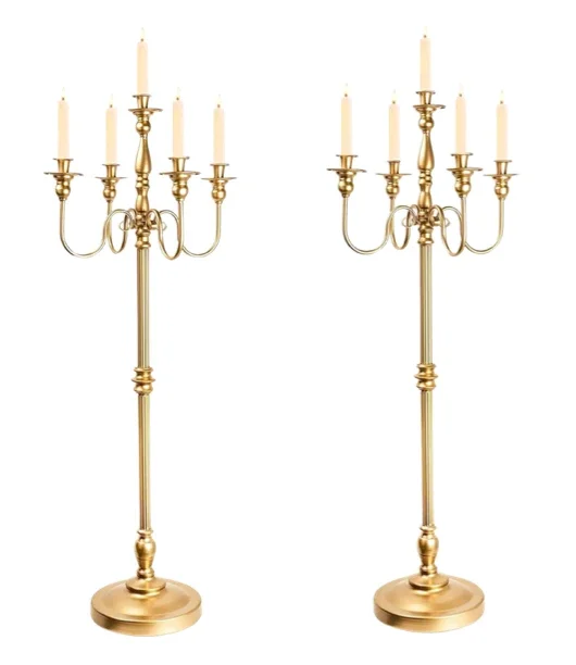 Two gold-colored candelabras with seven candles each against a white background.