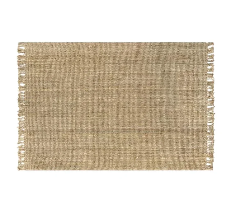A rectangular beige woven rug with fringes on both shorter sides.