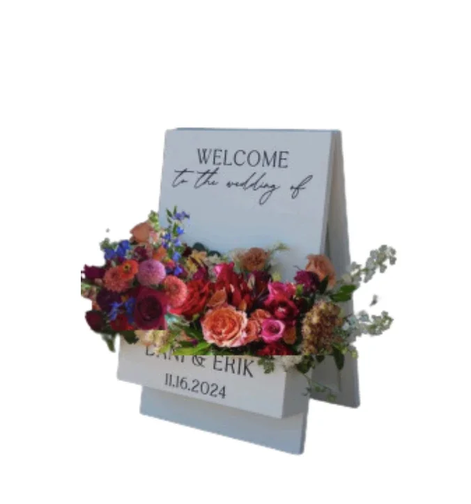 Wedding welcome sign with floral arrangement for LISA and ERIK, dated 11.16.2024.