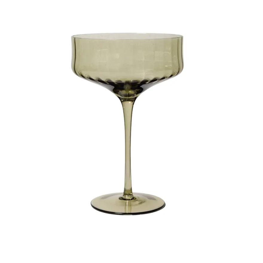 A translucent, pale yellow glass with a long stem and a wide, rounded bowl.