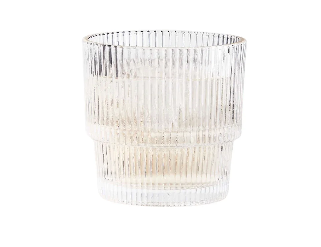 A clear, textured glass tumbler with vertical ridges.
