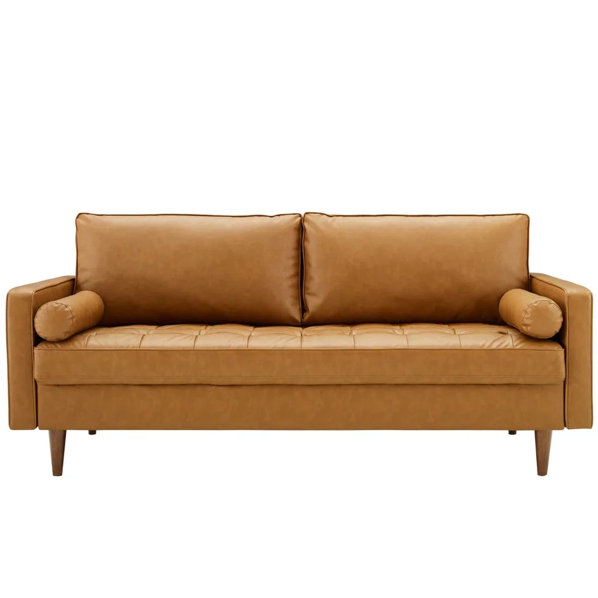 A tan mid-century modern sofa with tufted seat cushions, two back cushions, and two cylindrical bolster pillows.