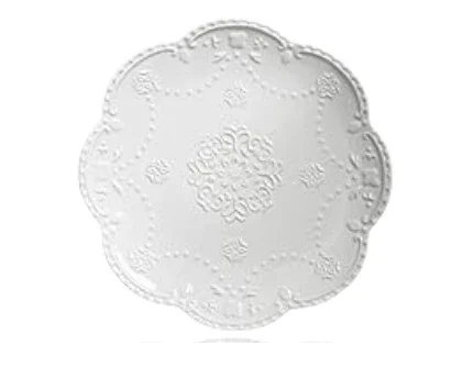 A white decorative round plate with embossed floral patterns.