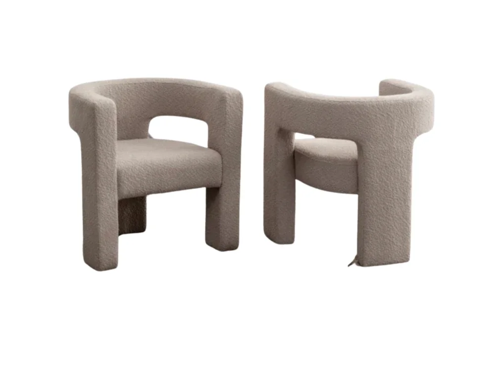 Two beige armchairs with a modern, rounded design and textured fabric, facing each other.