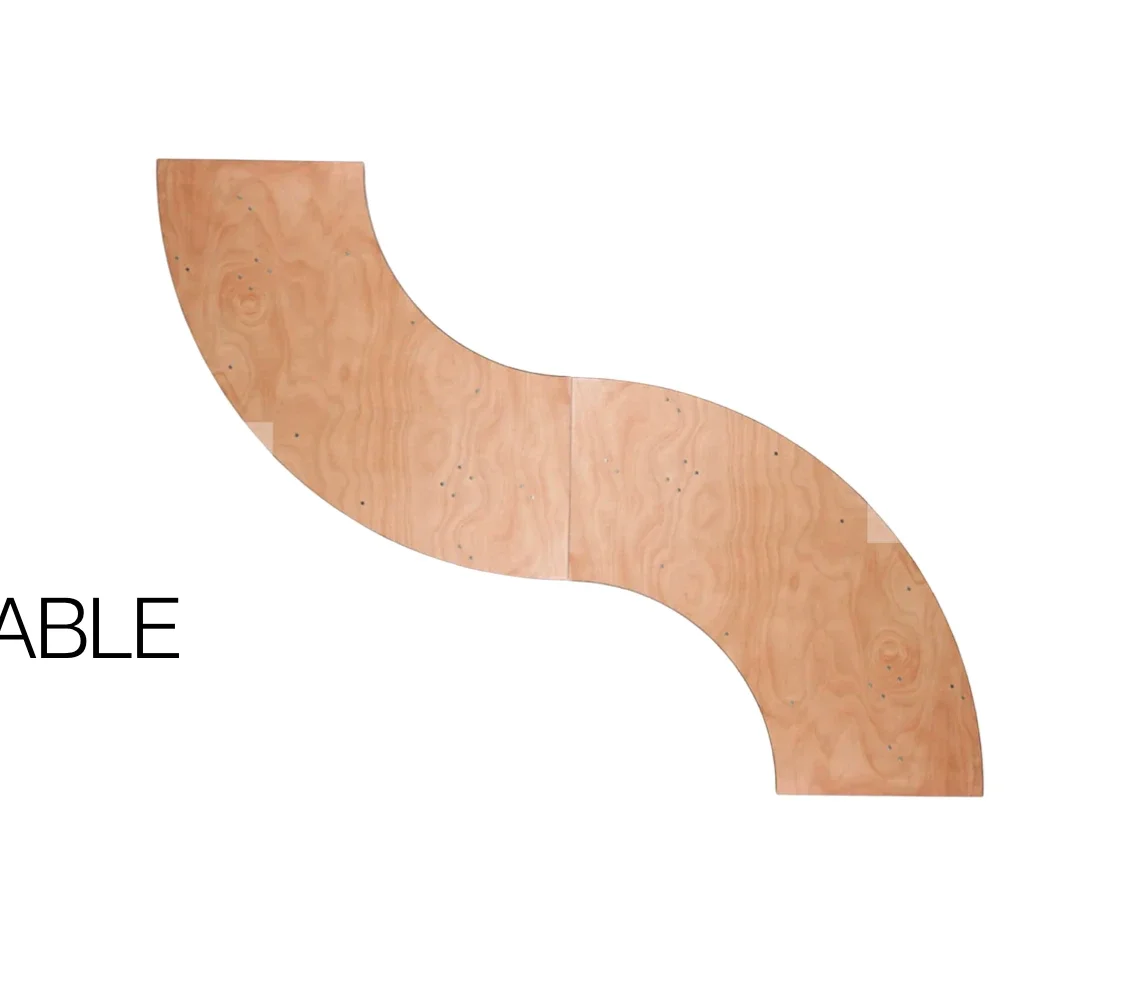Curved wooden ramp with a light wood finish and screws, used in skateboarding or roller skating.