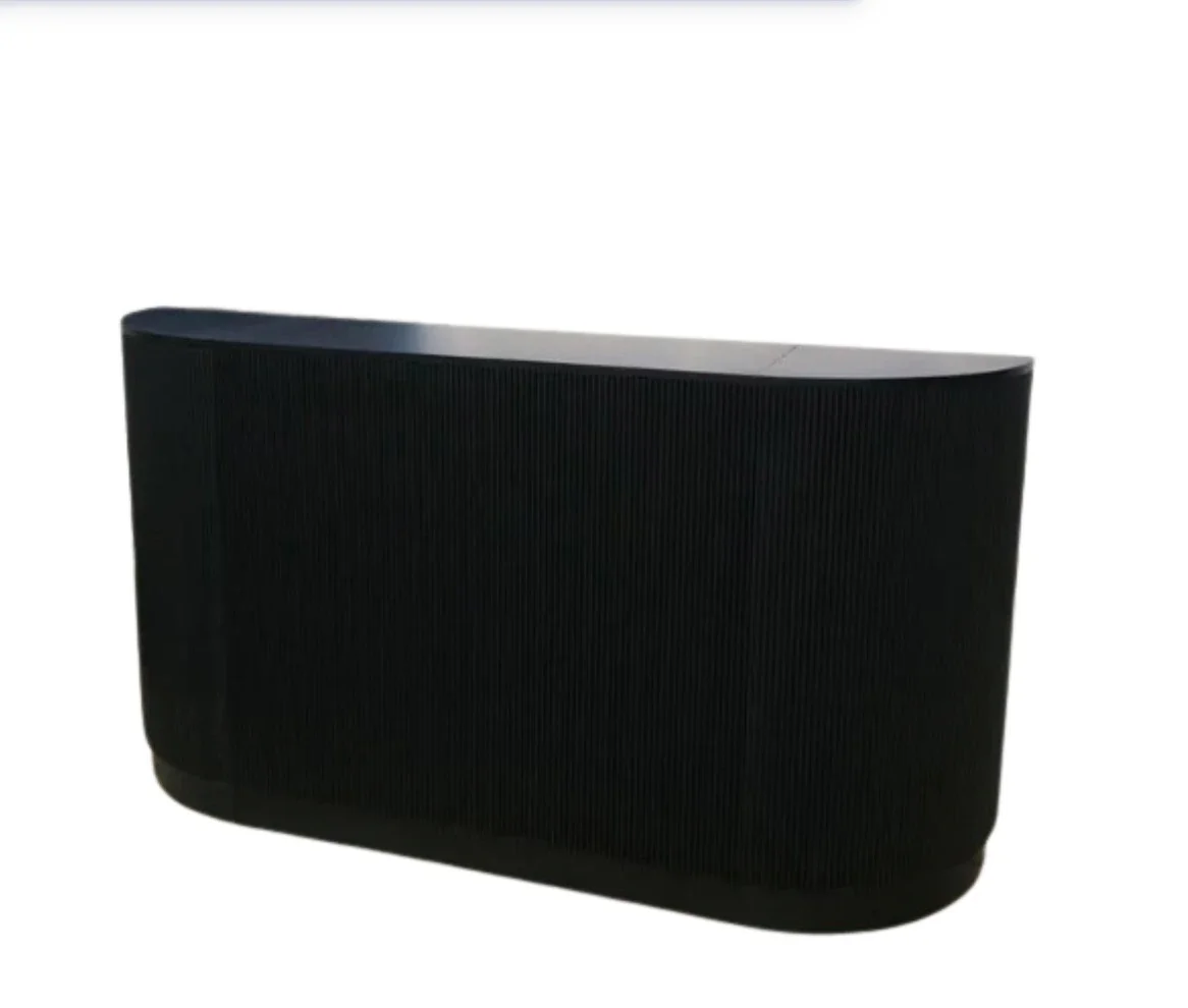 Black speaker with a curved front and textured grill material.