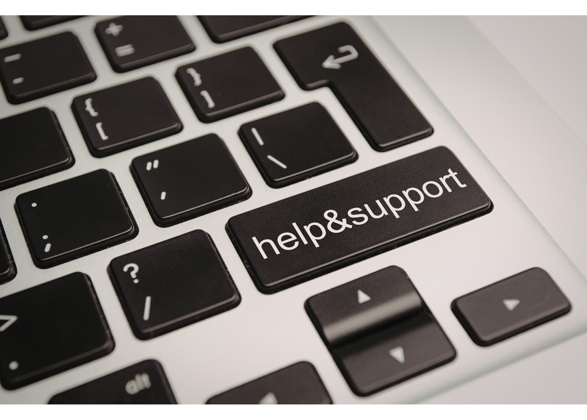 Close-up of a computer keyboard with keys labeled 'help' and 'support'"
