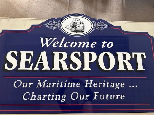 Sign that reads 'Welcome to SEARSPORT. Our Maritime Heritage... Charting Our Future' with a sailboat logo at the top.
