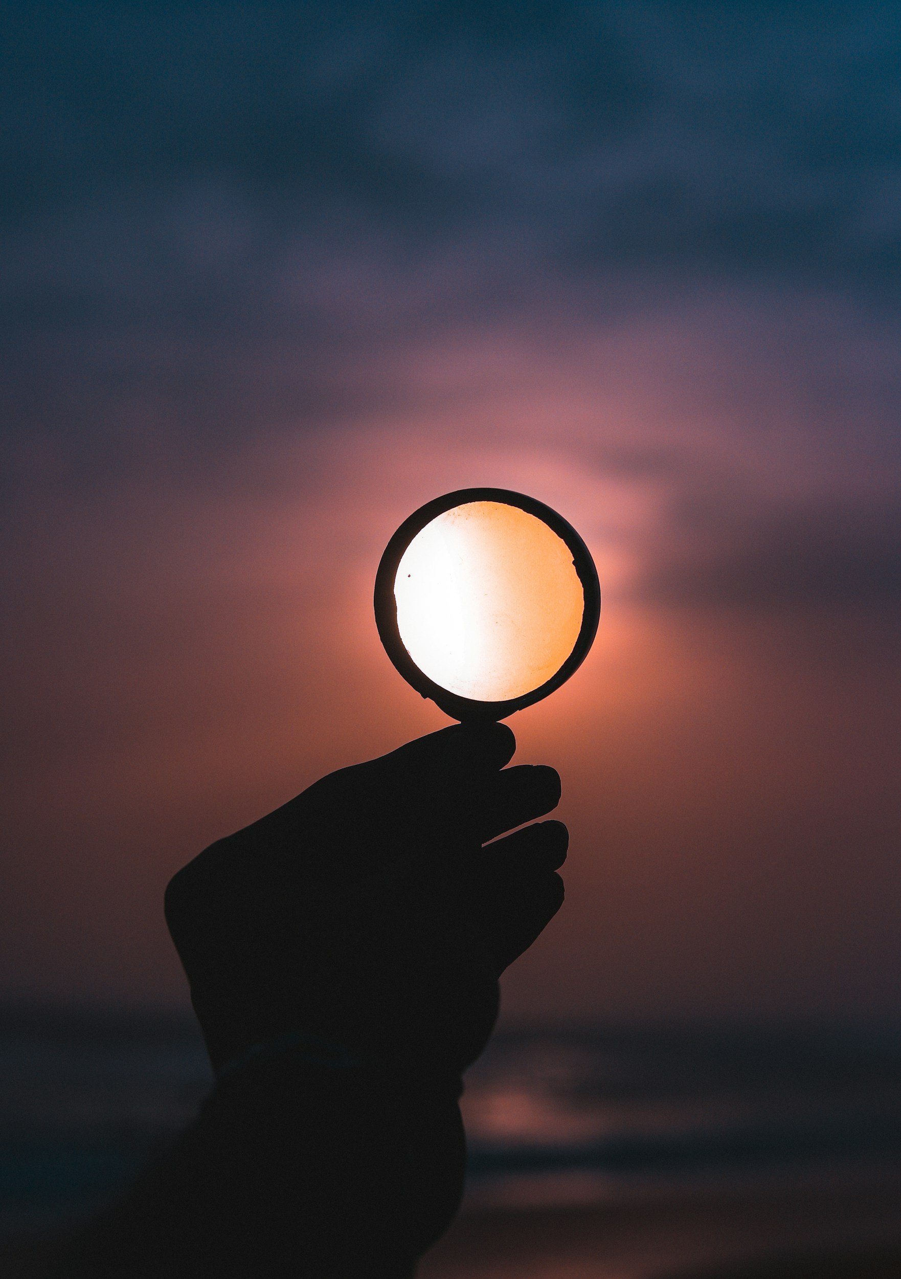 Magnifying glass against dark sky