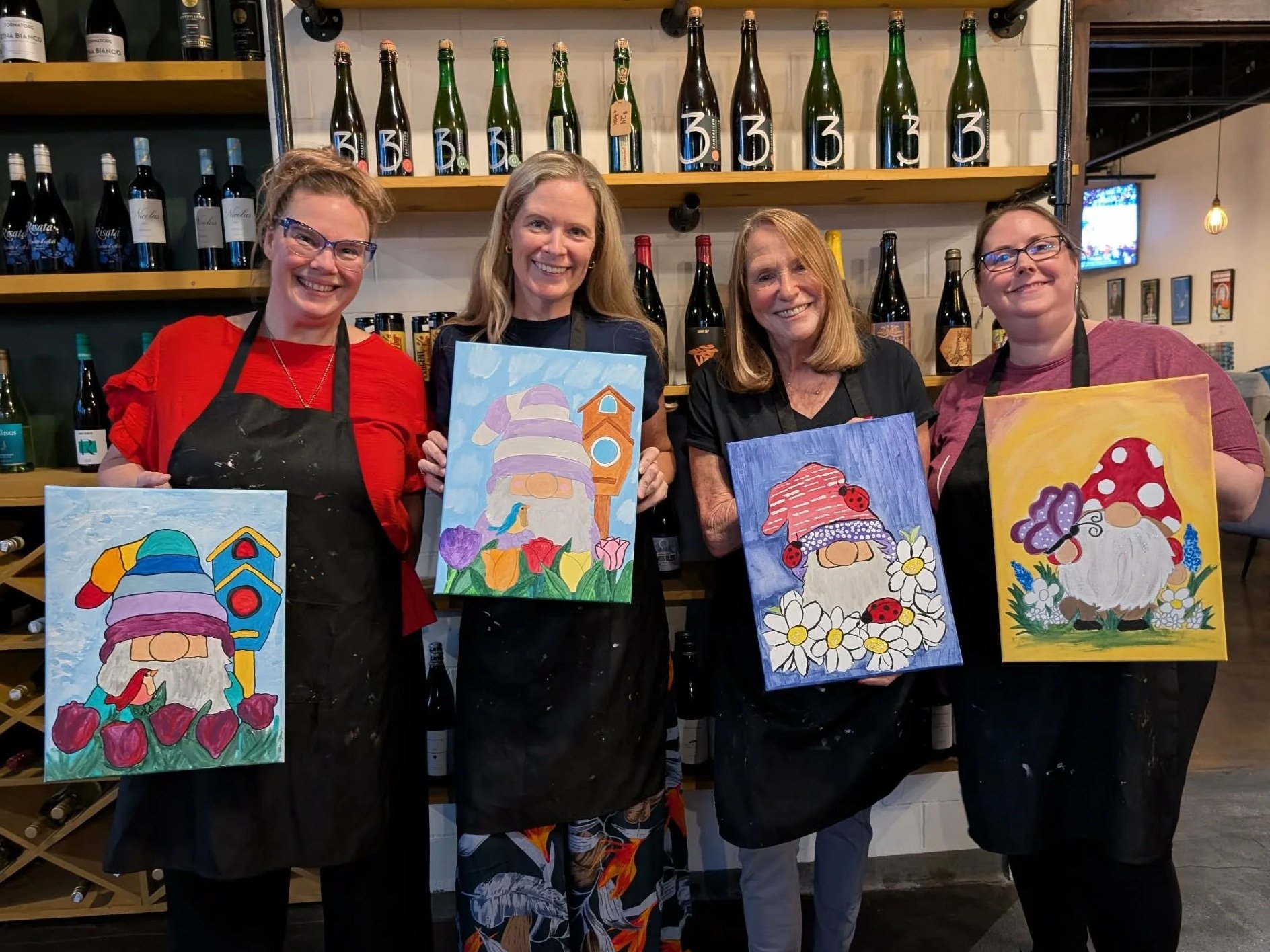 group of friends with finished gnome paintings