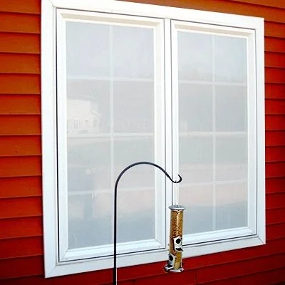 Window on exterior of house treated with CollidEscape perforated window film 