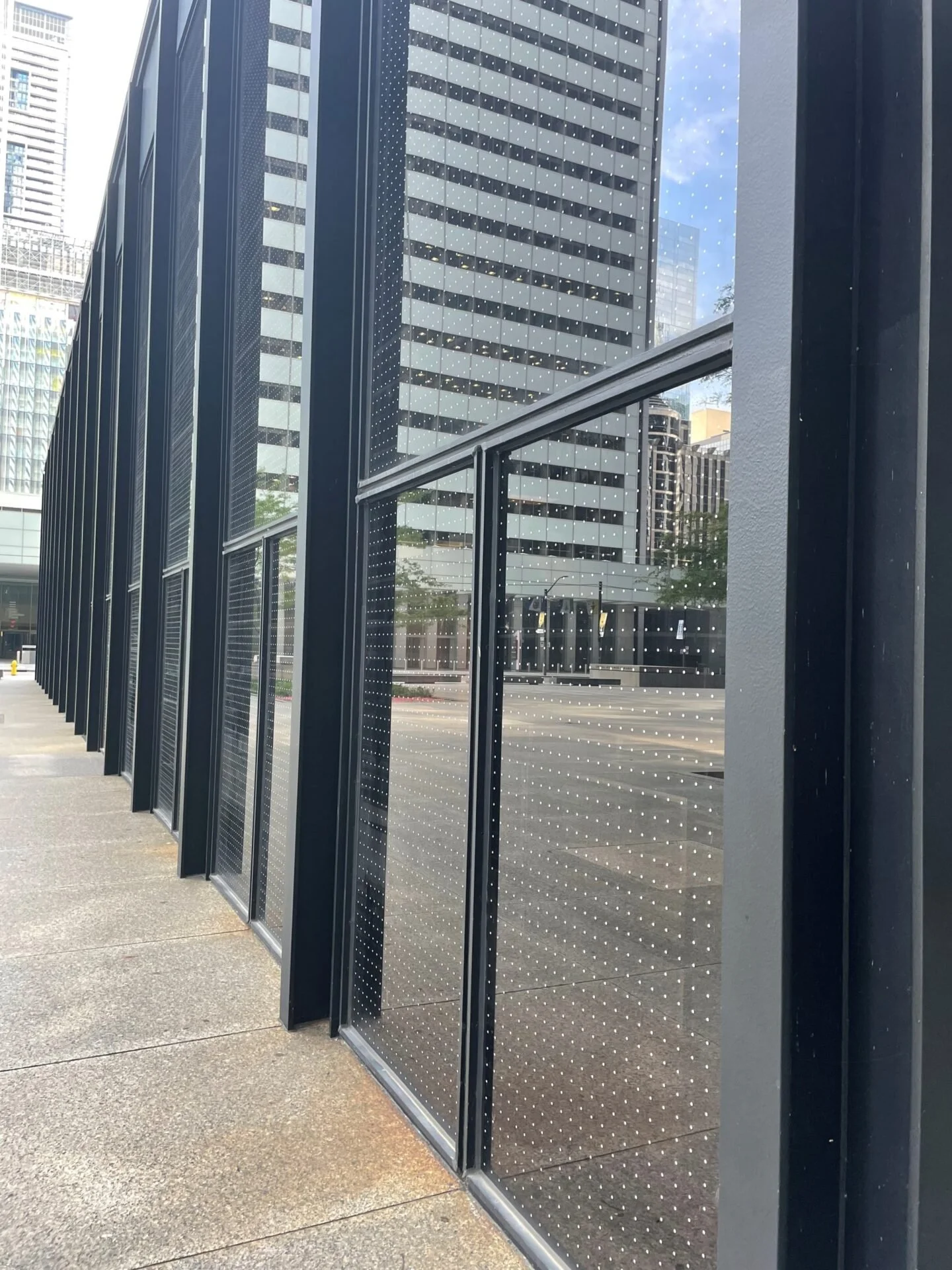 Close up image of windows of Toronto office building that installed bird-safe markers by Feather Friendly onto their windows in 2021