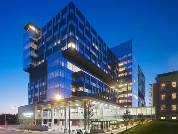 Large commercial building bright and lit up at night, showcasing the risk to migrating birds at night
