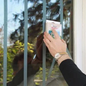 CollidEscape tape applied to exterior residential window as bird window collision prevention method