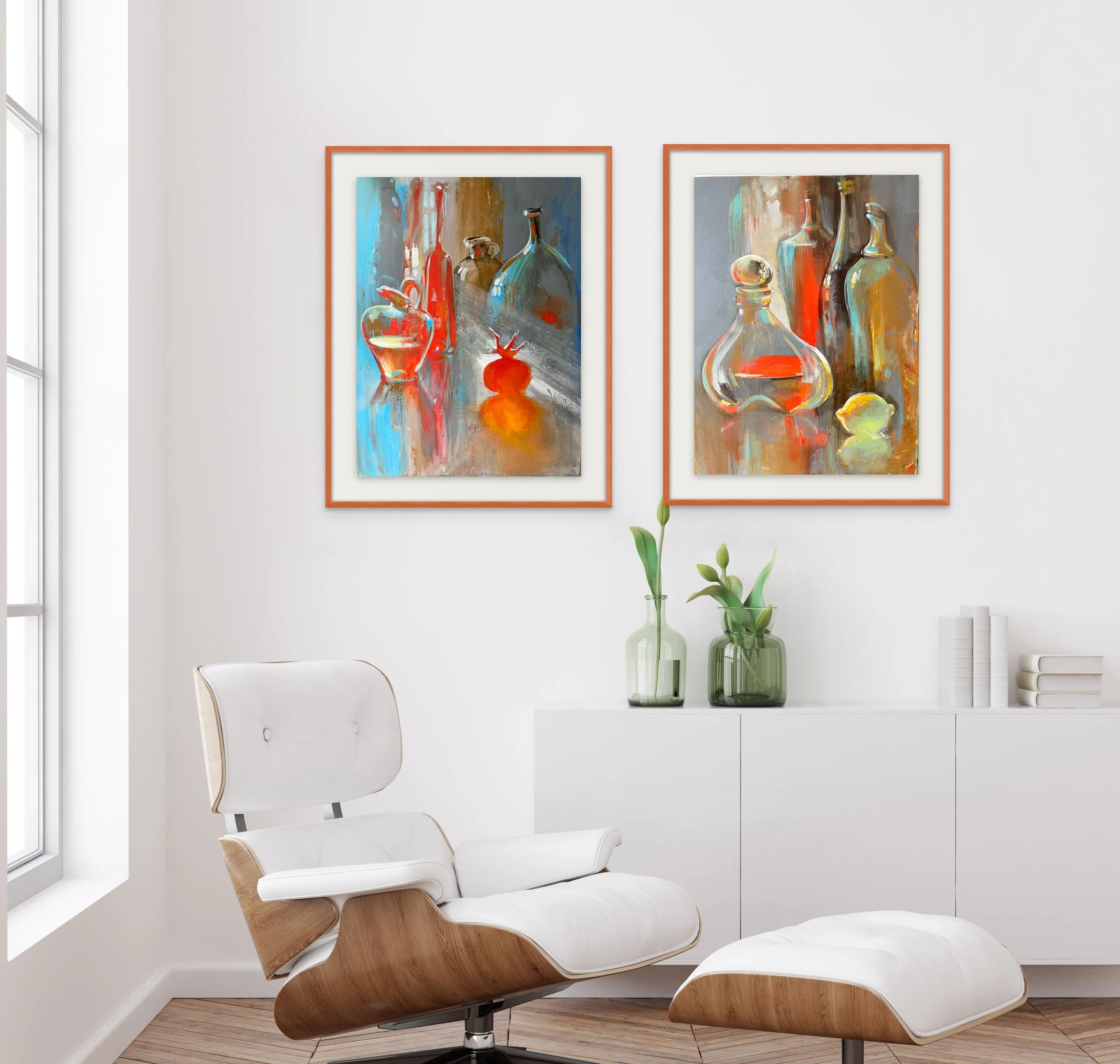 Interior of a modern room with white walls, artwork of colorful bottles hanging above a white cabinet, and a white and wood lounge chair with matching ottoman.