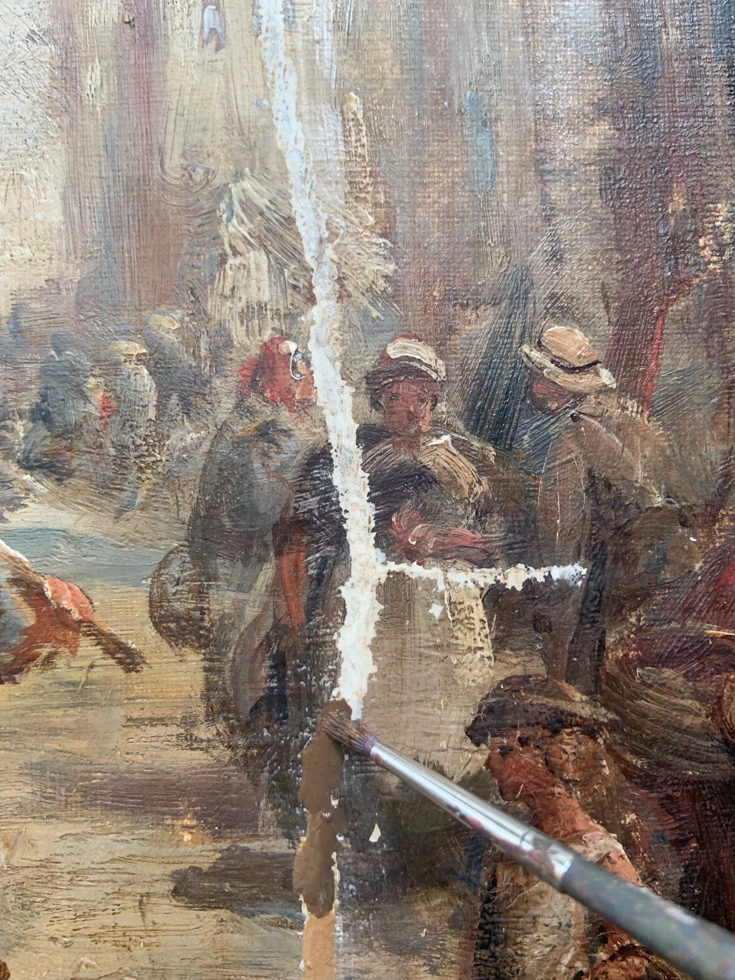Close-up of a painting in progress showing a group of people, with visible brush strokes and some areas of the canvas being cleaned or restored, including a paintbrush and a vertical tear in the artwork.
