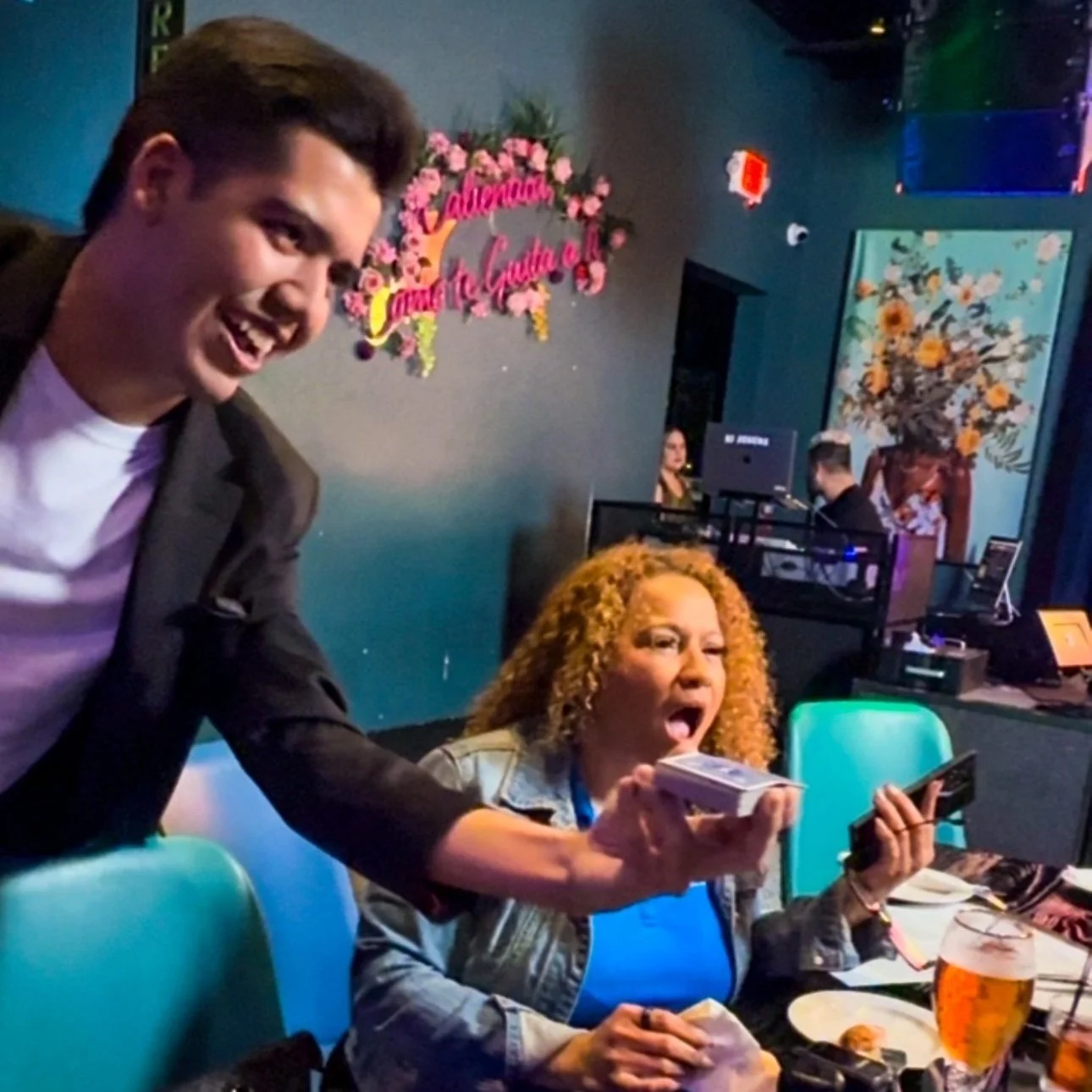 Comedy magic show in Miami featuring a magician connecting with a mixed-language audience, blending visual magic with witty banter and engaging storytelling