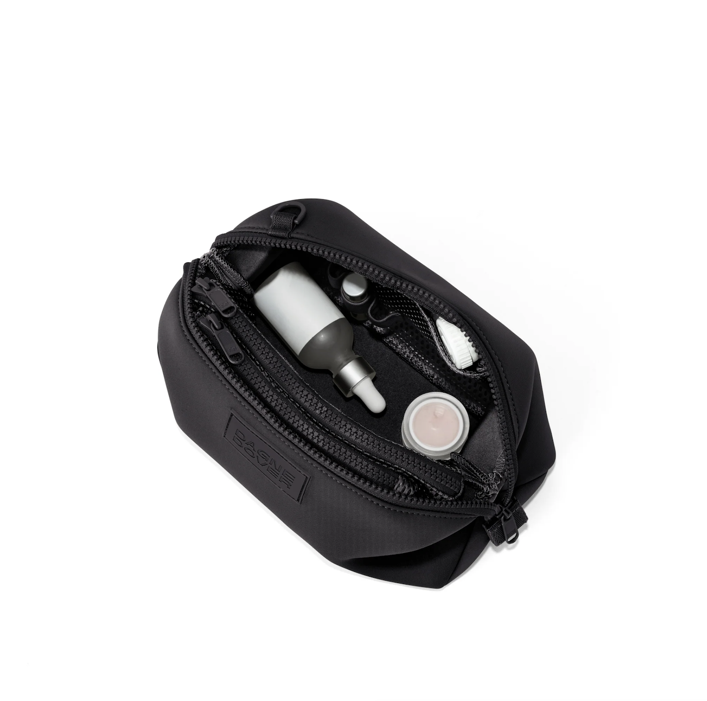 Black travel toiletry bag with toiletries inside, including a dropper bottle, a small container, and a tube.