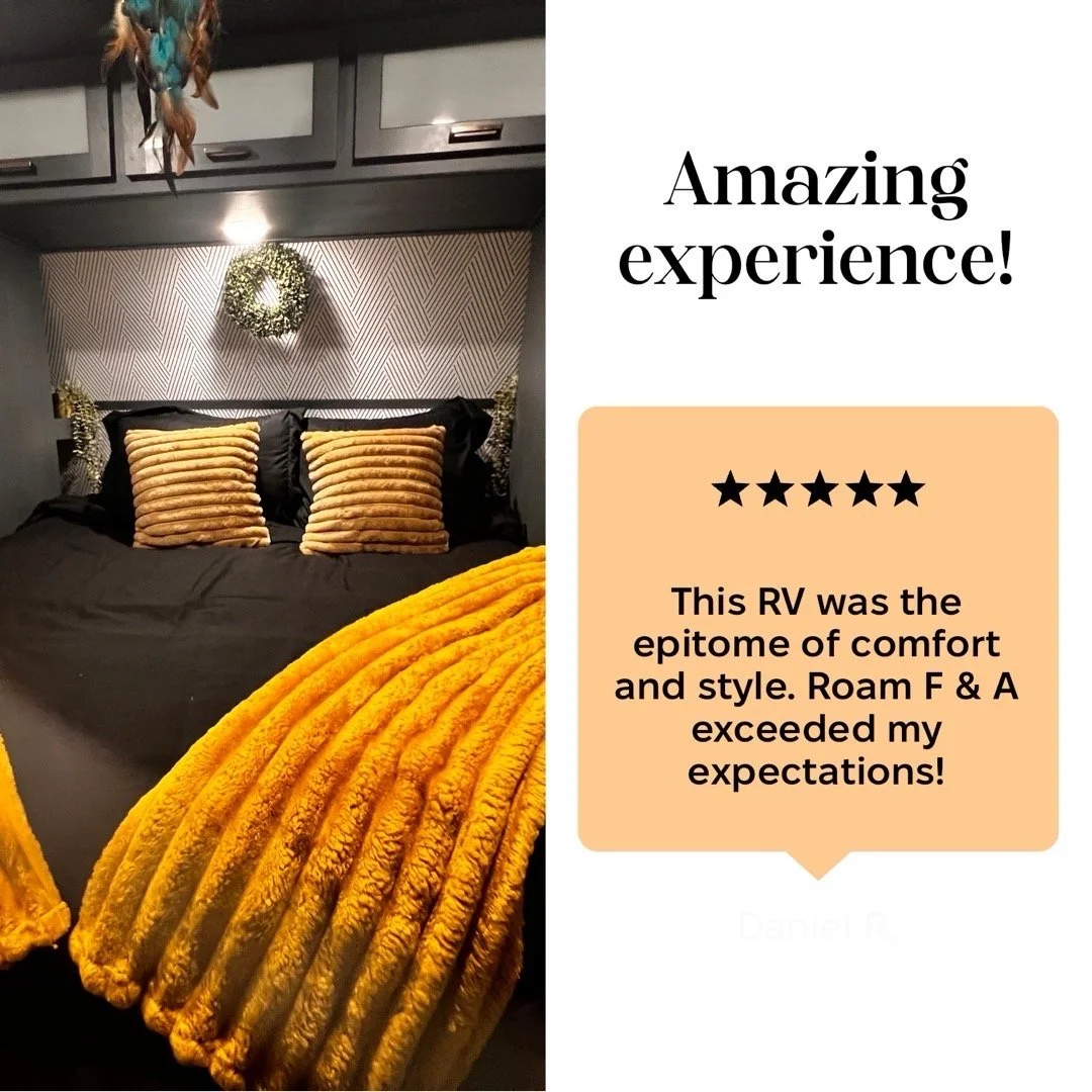 A cozy bedroom inside an RV with dark bedding, striped pillows, decorative sconces, a wreath on the wall, and a plush mustard yellow blanket. The right side shows a review with the text: "Amazing experience! 5 stars. This RV was the epitome of comfort and style. Roam F & A exceeded my expectations!"