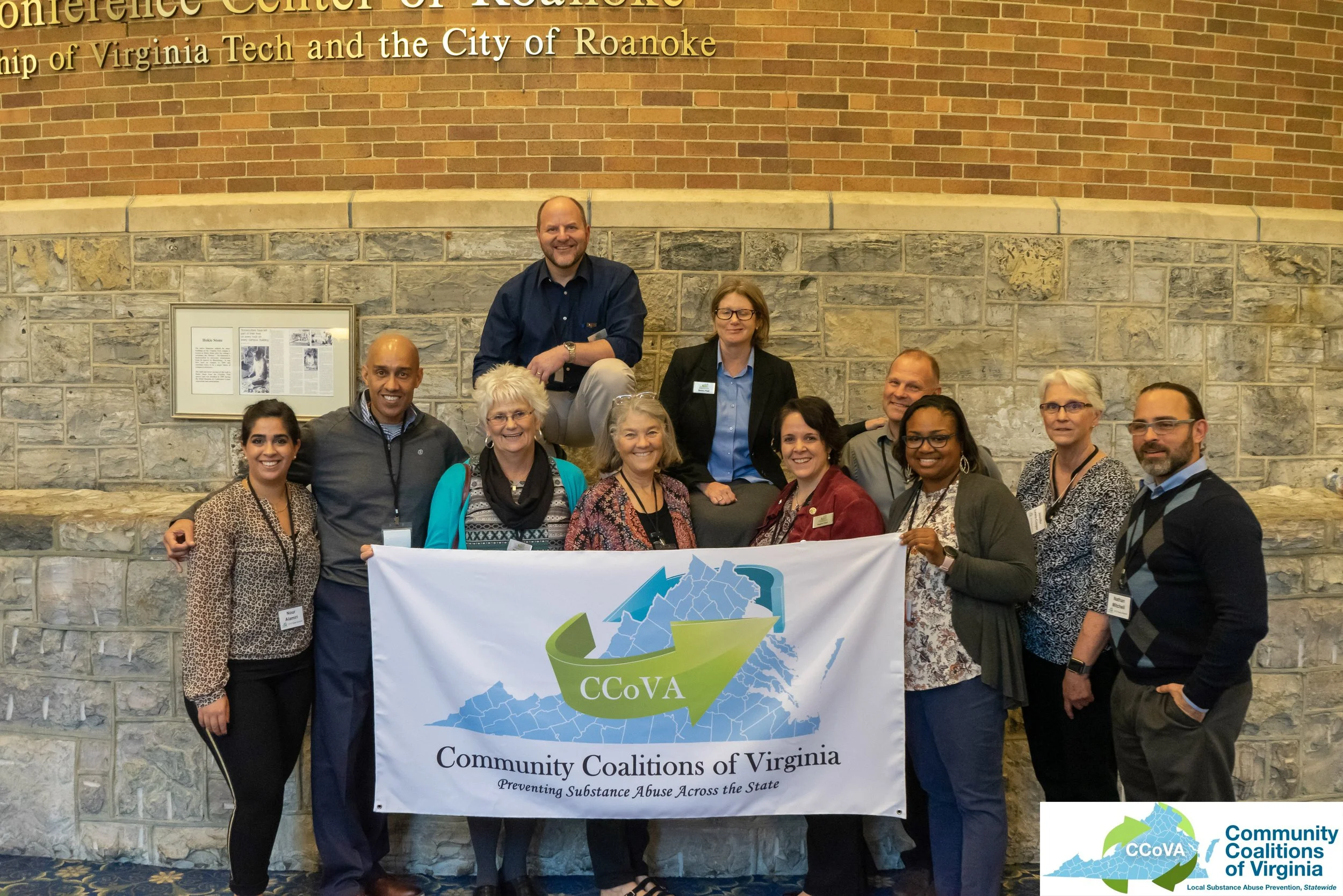 A group of people holding a banner for CCoVA