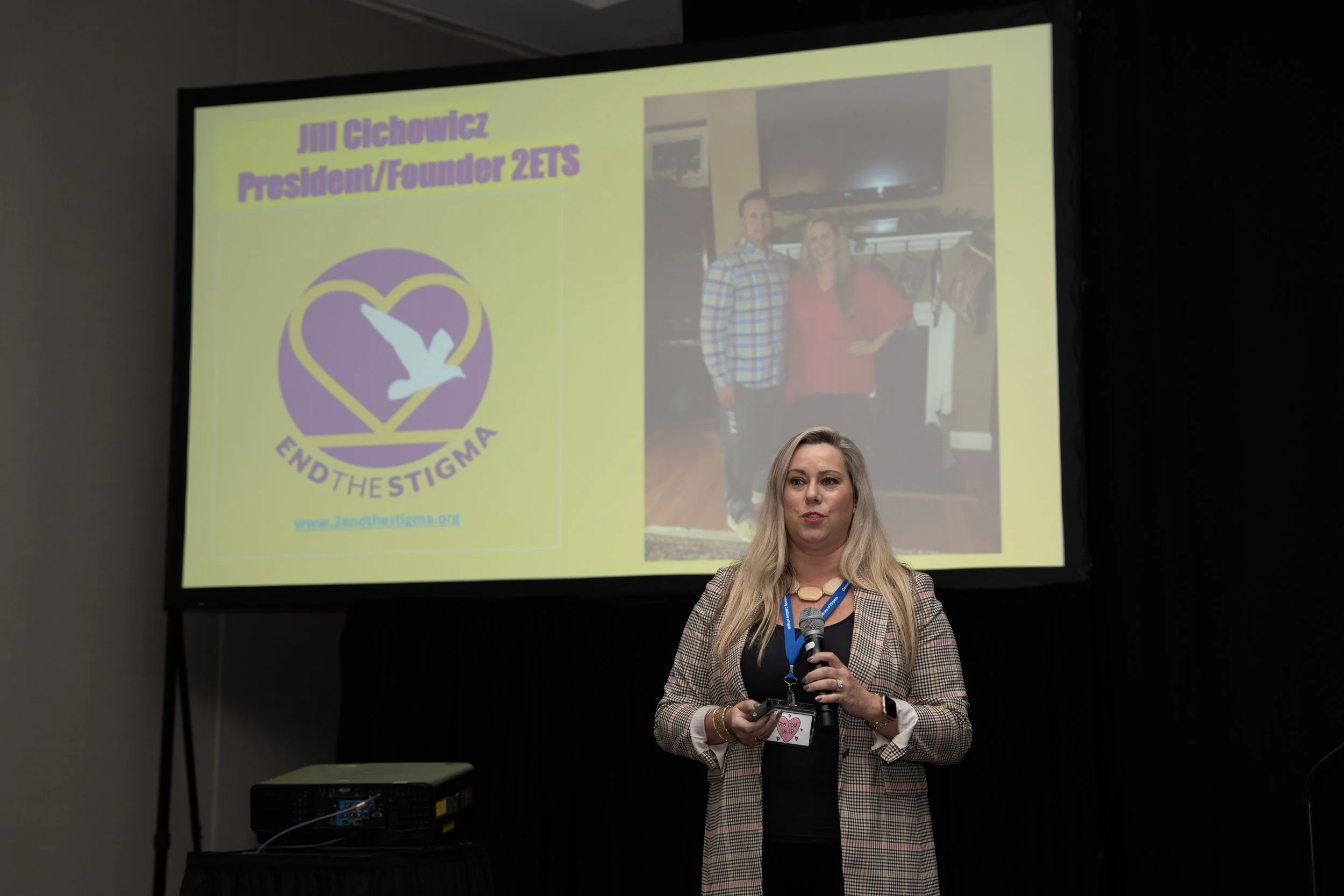 Conference presenter in front of projector screen
