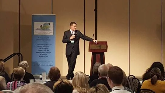 Male speaker addressing audience from the podium