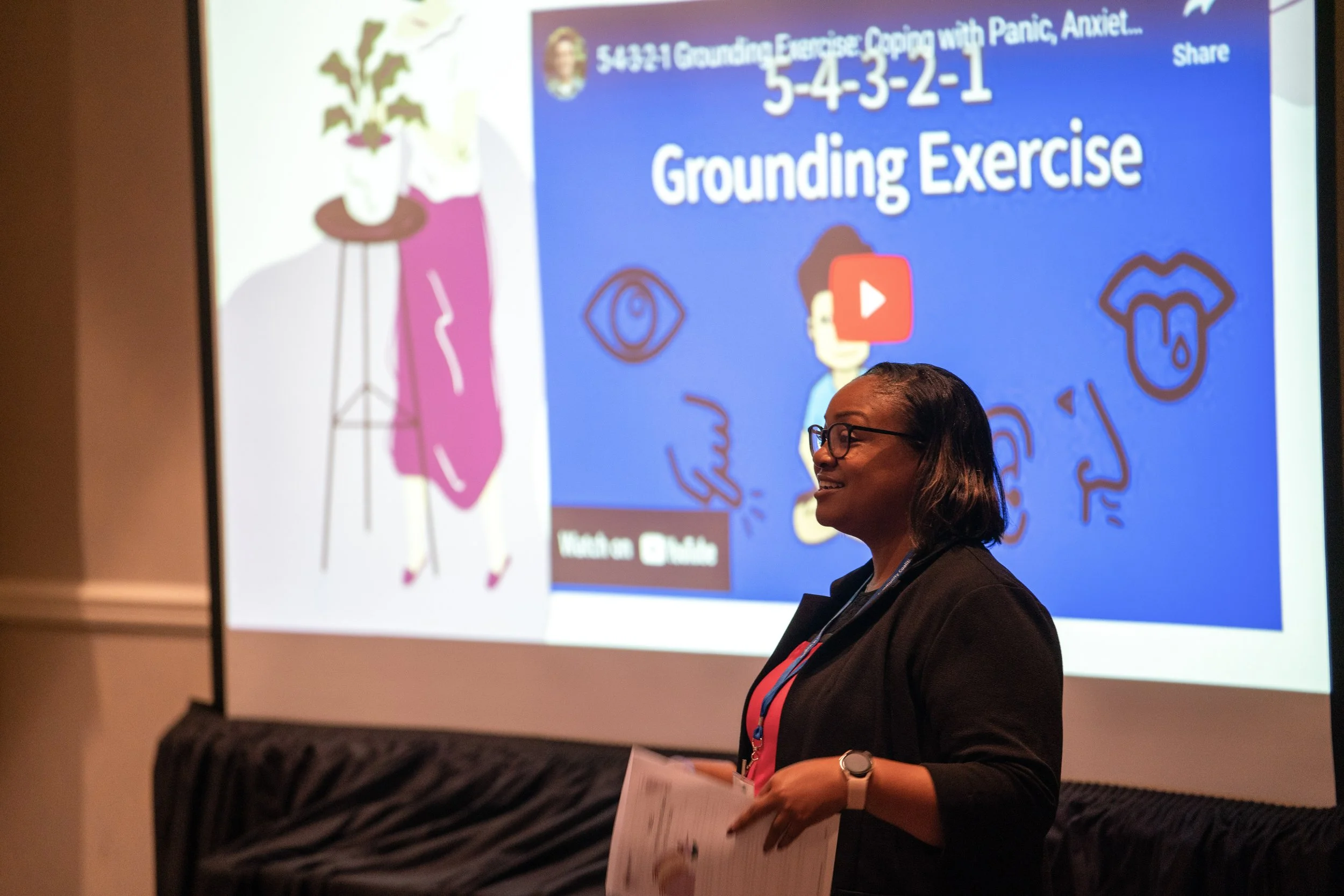 Presenter in front of projector screen