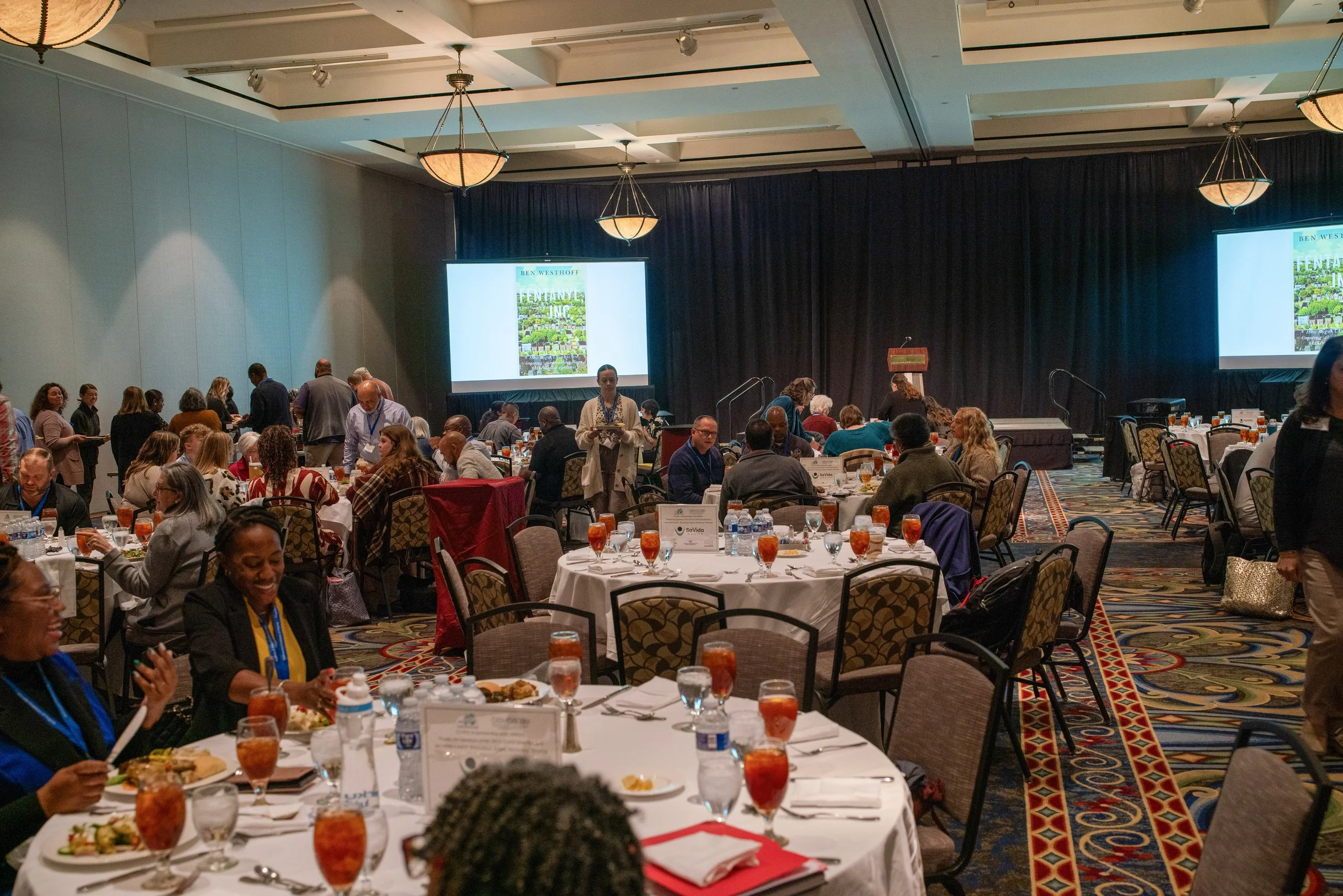 Conference attendees eating lunch in main ballroom