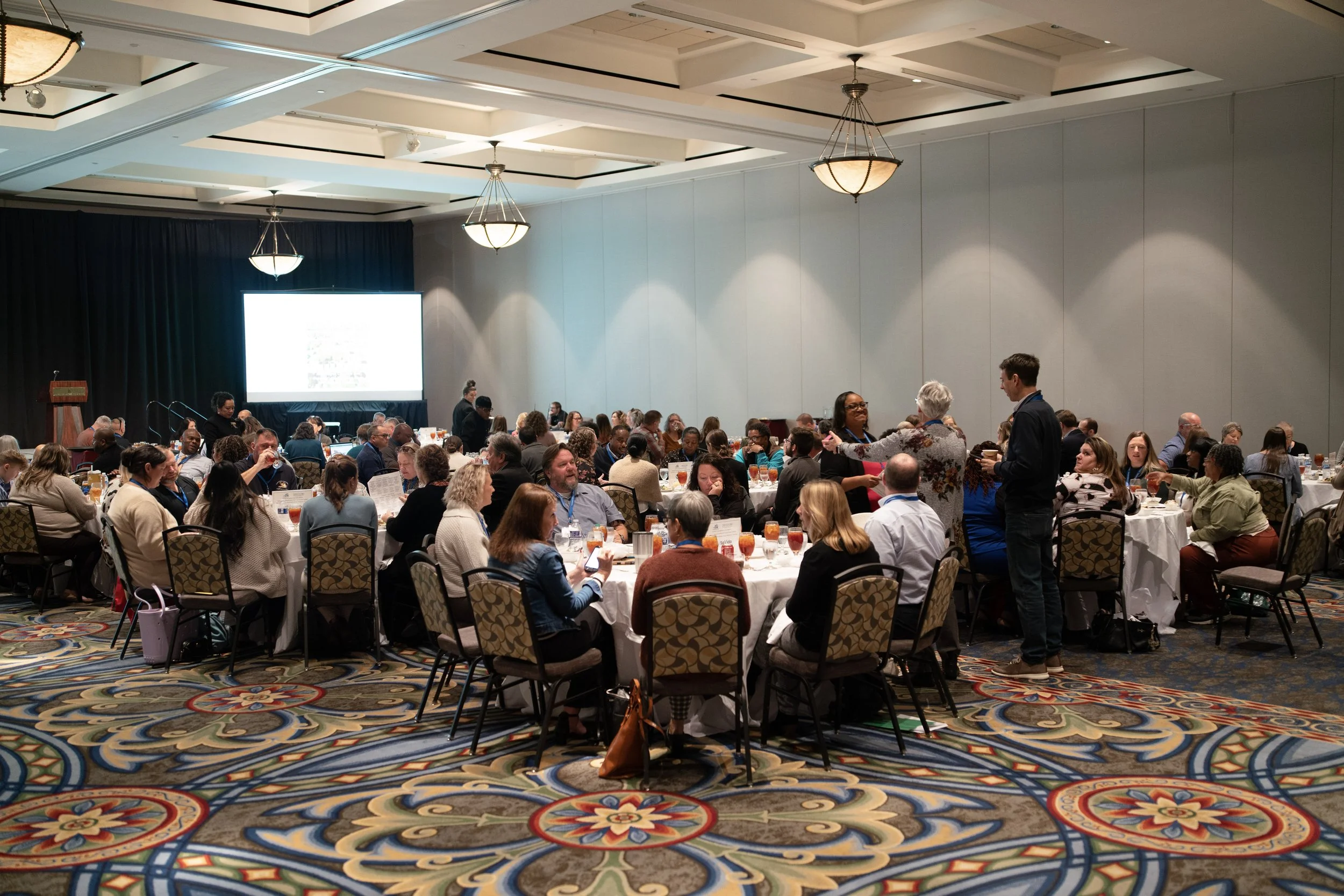 Conference attendees eating lunch in main ballroom